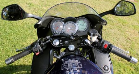 Cockpit view: Instruments are functional. Polished handlebar weights roll freely when twisted. Hitting the red right-side kill button shuts off the electricity to the instruments but leaves headlights on. Note lockable right side compartment in fairing. Very handy.